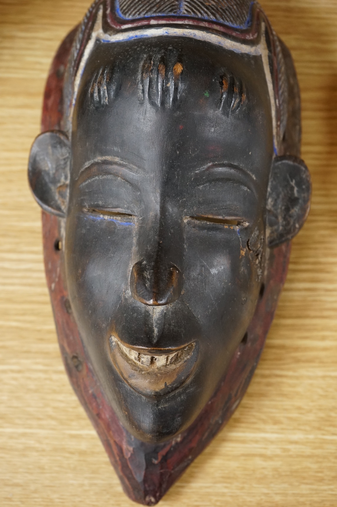 A carved African Ivory Coast mask, 39cm high
